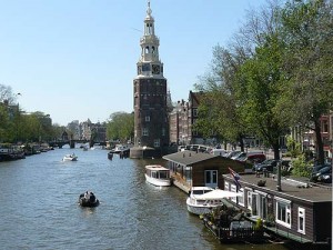 Uno de los grandes canales de Ámsterdam con una embarcación navegando